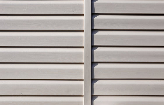 Installation on facade of the house panels beige vinyl siding