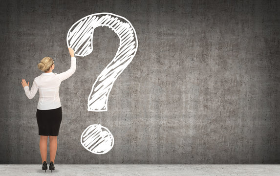 businesswoman drawing sign ? on a blackboard. business concept
