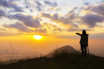 Traveller silhouette on the sunset background.