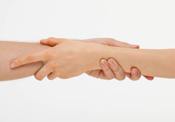 Man's hand gently holding woman's hand