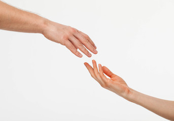 Hands of man and woman reaching out to each other