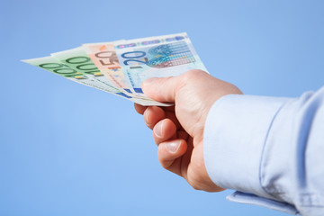 Businessman's hand reaching out euro banknotes