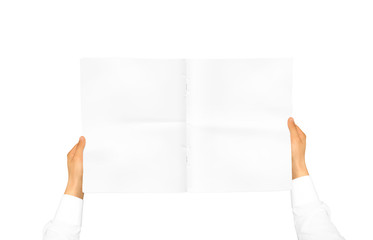 Hand in white shirt sleeve holding blank journal in the hand. Empty magazine presentation. Pamphlet...