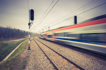 Blurred train of Koleje Malopolskie on double railway track, Krakow, Poland