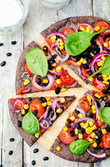 Black beans crust pizza with corn, spinach, tomatoes, black bean