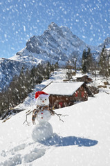 Snowman against Alpine panorama