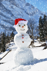 Snowman against Alpine panorama