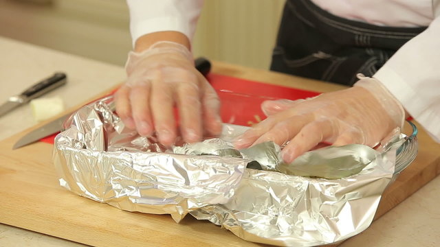 Chef is marinating fish fillet to bake in foil