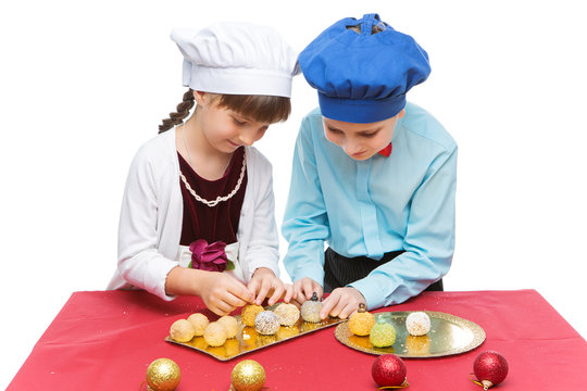 Children cooking christmas dessert