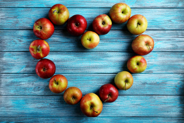 Fresh apples on a blue wooden table