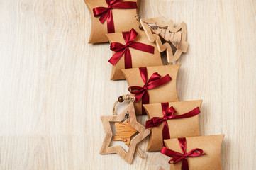 Handmade Christmas gifts from kraft paper and wooden toys on the Christmas tree