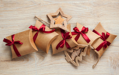 Handmade Christmas gifts from kraft paper and wooden toys on the Christmas tree