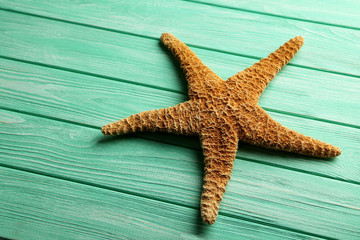 Starfish on a mint wooden table