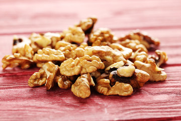 Walnuts on a red wooden table