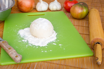 Freshly baked artisan pizza with fresh produce and cheese.