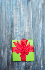 Fototapeta premium Christmas Present wrapped in paper on a wooden background for a