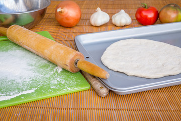 Freshly baked artisan pizza with fresh produce and cheese.