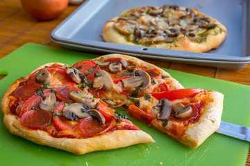 Freshly baked artisan pizza with fresh produce and cheese.