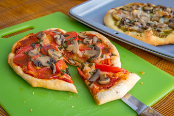 Freshly baked artisan pizza with fresh produce and cheese.