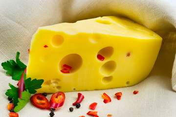 a piece of cheese with spices on canvas