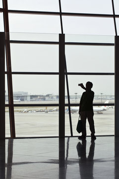 Man takes a photo on Beijing Capital Airport