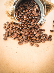 Coffee roasted bean in the bucket on wooden background