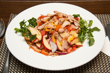  cold salad with pork meat, tomato and apple