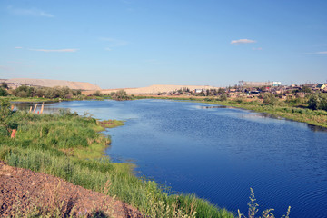Rural area in the town of Mirny, Irelyakh bridge over the river.
