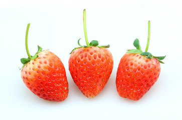 Three fresh strawberries isolated on white background.