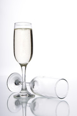 Glass of champagne and empty champagne glass