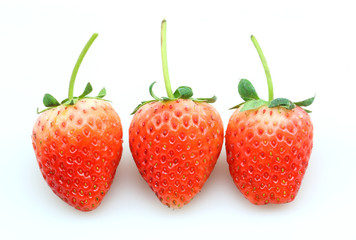 Three fresh strawberries isolated on white background.