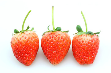 Three fresh strawberries isolated on white background.