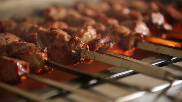 Cook roasts juicy kebab barbecue with crispy grilled slowmotion