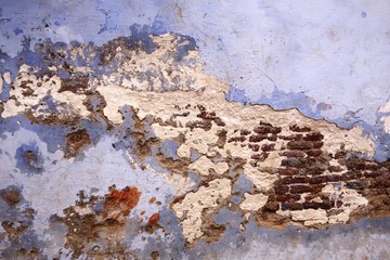 Old brick wall partially damaged in India
