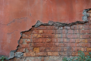 Old brick wall partially damaged in India