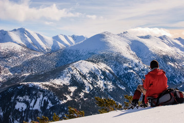 Man is resing in high snowy mountain. Rila, Bulgaria.