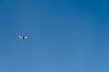 Fototapeta na wymiar Airplane On Clear Blue Summer Sky