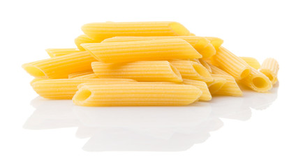 Dried penne regate pasta or cylinder shaped pasta over white background