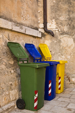 Three colorful recycling bins
