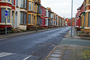 A street of boarded up derelict houses awaiting regeneration in