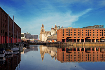 Naklejka premium The Albert Dock and Liver Buildings in Liverpool UK on a beautif