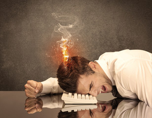 Obraz premium Sad business person's head catching fire
