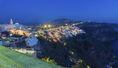 The picturesque panoramic view from the height on the town of Fira and the surrounding area at night .Fira is the capital of the island Santorini (Thira).Cycladic archipelago.Greece.Europe. © luxerendering