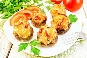 Champignons stuffed meat in white plate on green napkin