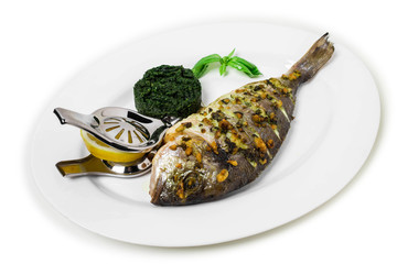 Grilled sea bass with spinach garnish.