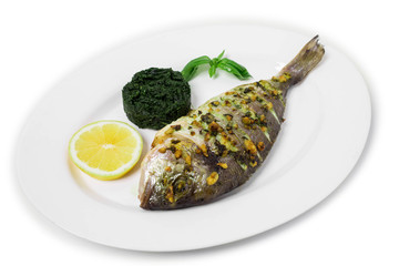 Grilled sea bass with spinach garnish.