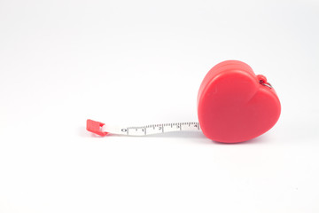 Measuring tape in heart shape on white background