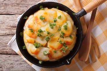 Homemade baked potatoes in a pan close-up. horizontal top view
