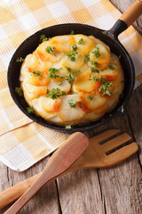 French Potato baked in a pan close-up. vertical
