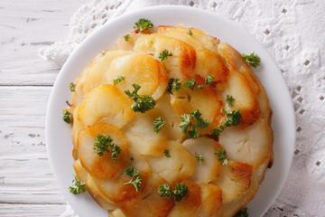 Potato casserole on a white plate closeup. Horizontal top view
